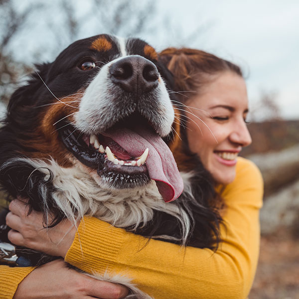 pretty woman hugging her dog