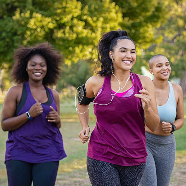 three young female friends running